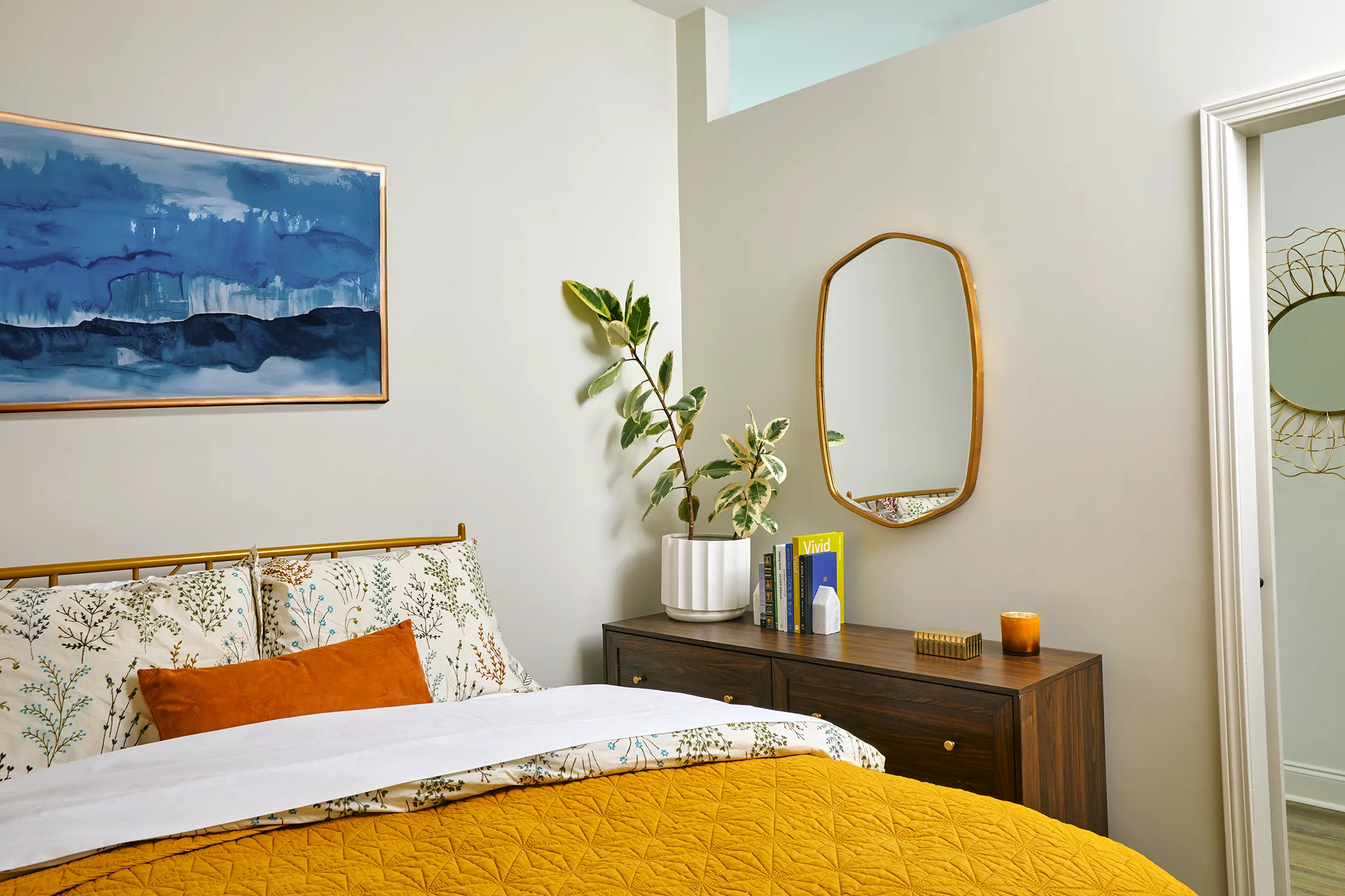 Warm bedroom at The Tribute Knoxville, TN, featuring soft lighting, cozy bedding, and inviting decor for a comfortable and relaxing space